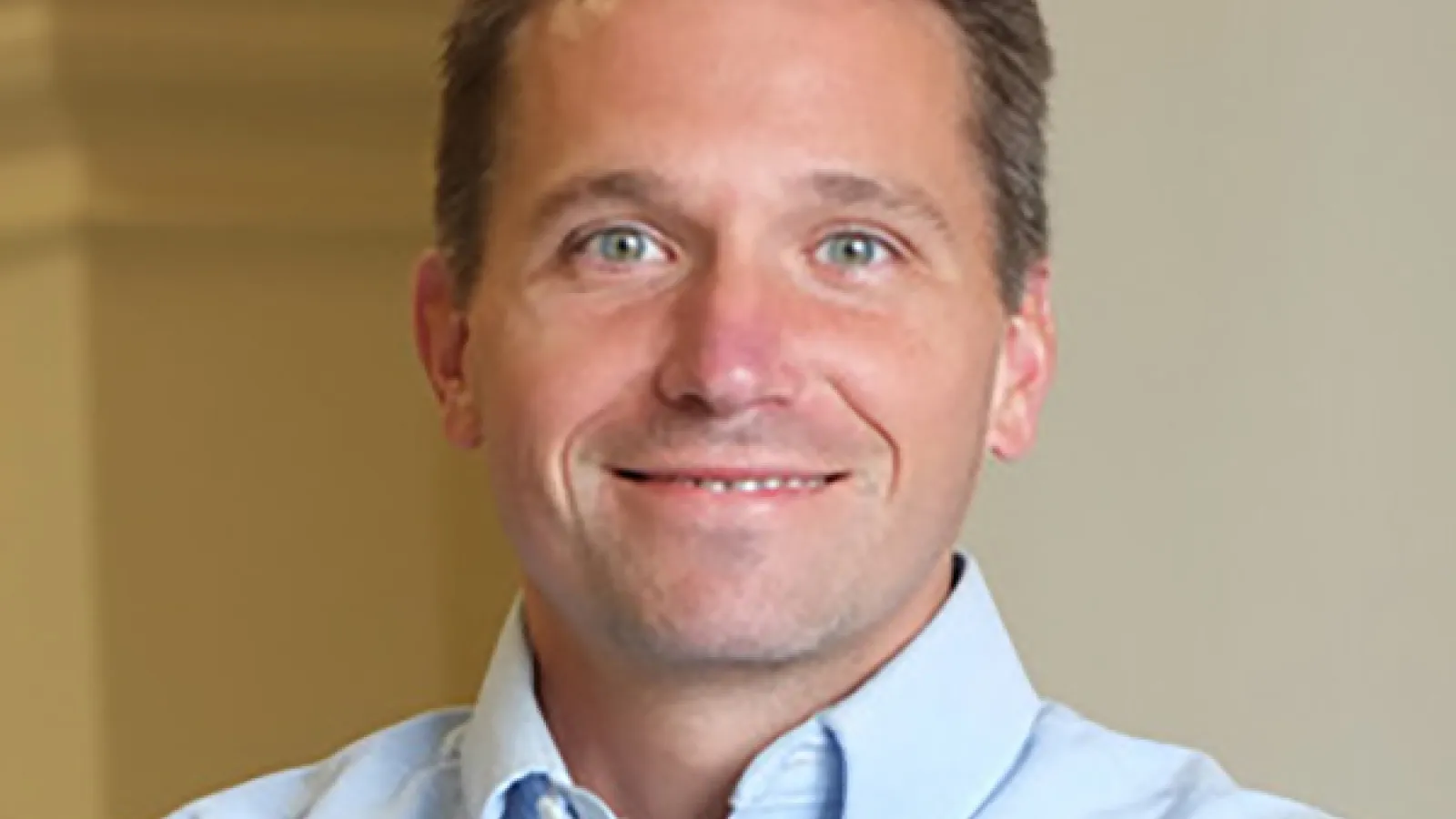 Professor Derek Sawyer smiling with arms folded