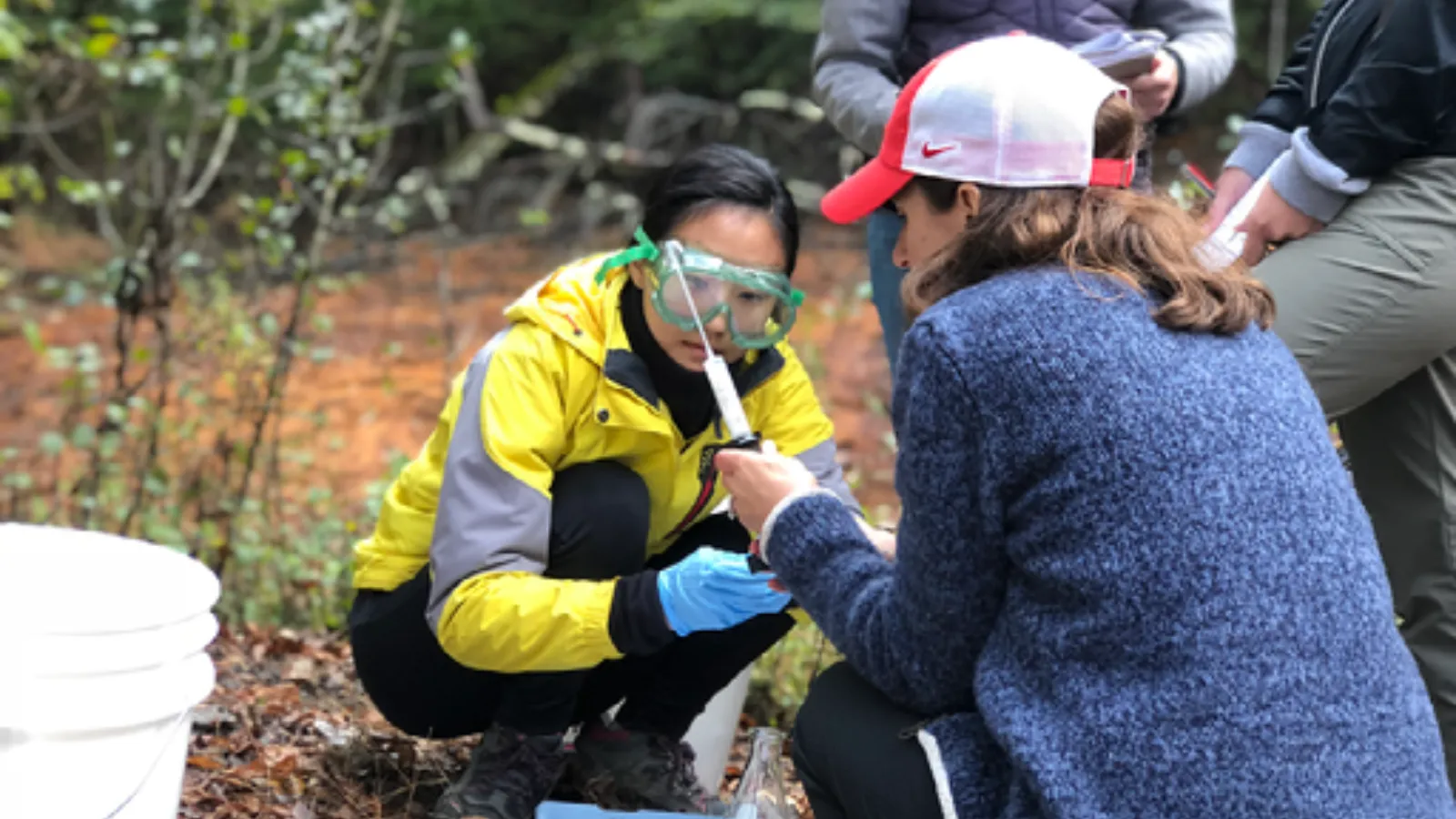 Alum Dr. Ji-Eun Kim and Professor Liz Griffith test water samples during a field trip for the Introduction to Geochemistry course.