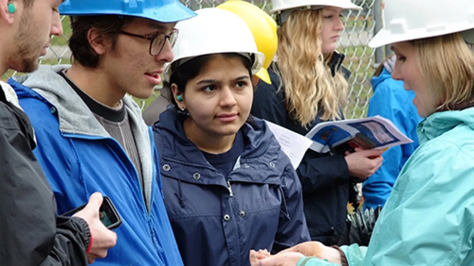 Photo of students in Water Issues class learning how to describe cuttings from the well that was drilled on campus