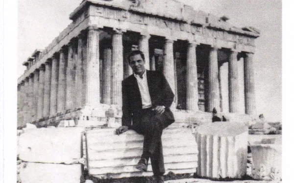 Thomas Anderson as a young man sitting on columns in front of the Parthenon in Greece
