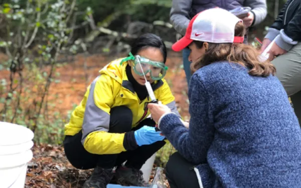 Alum Dr. Ji-Eun Kim and Professor Liz Griffith test water samples during a field trip for the Introduction to Geochemistry course.