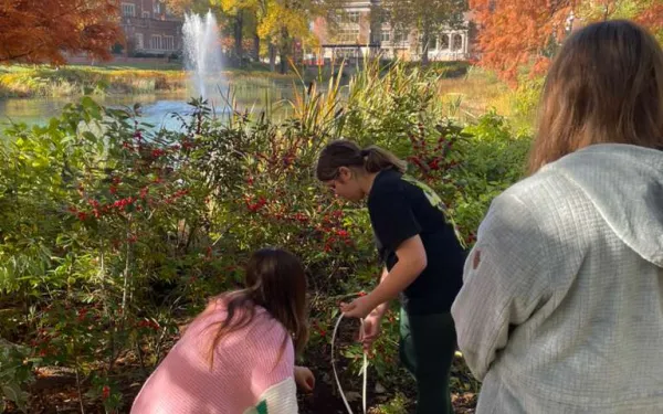 This image shows Madison Schaefer leading an activity abou contaminant transport in aquifers. See how a contaminant spreads between grains, pull contaminated water from a “well”, and filter it through activated carbon.