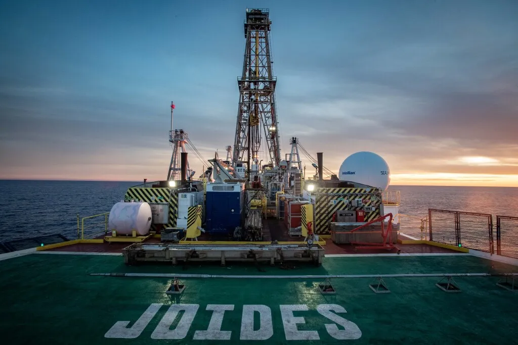 A view of the JOIDES Resolution's derrick from the helideck at sunrise. (Credit: Erick Bravo, IODP JRSO)