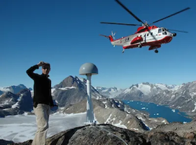 Geodetic graduate student waiting for a helicopter to land in Greenland