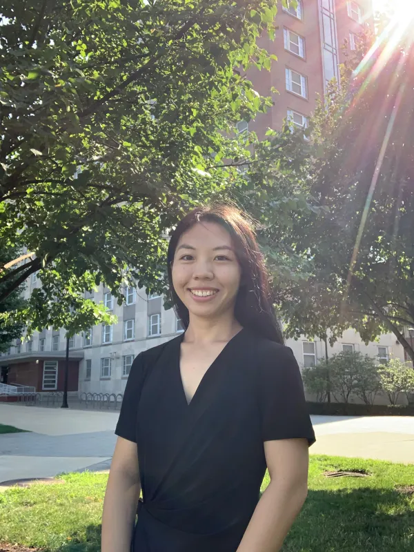 Yue standing in front of a building