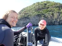 Dr. Ann Marie Hulver and Dr. Andrea Grottoli collecting water samples at the study site off the island of Ischia, Italy after scuba diving.